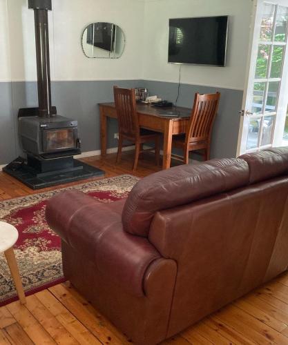 a living room with a couch and a wood stove at Aldgate Valley Bed and Breakfast in Aldgate