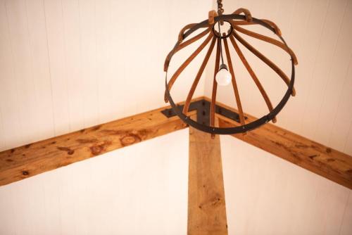 a wooden beam in a room with aiameter at The Salty Bushman B&B in Kaka Point
