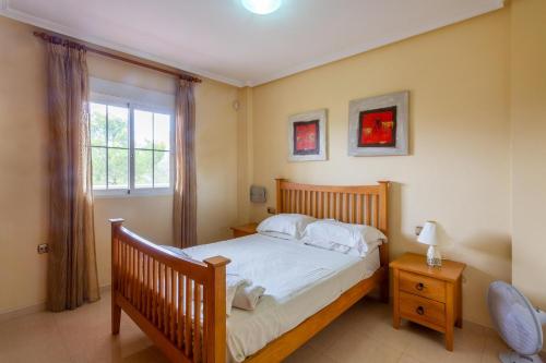a bedroom with a bed and a window at Playa Golf 2 in Cabo Roig