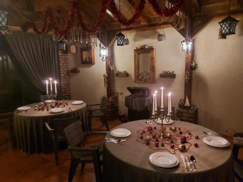 a dining room with two tables with candles on them at CASA LUCA in Moldova Nouă