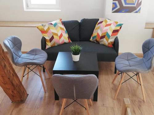 a living room with a couch and two chairs and a table at Life Hostel Slovenia in Radovljica