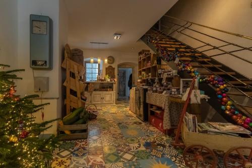 a living room with a christmas tree and a staircase at Holzwerk Oybin in Kurort Oybin