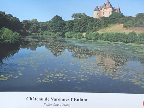 a painting of a castle on a hill next to a river at La casita de Vanessa in Changé