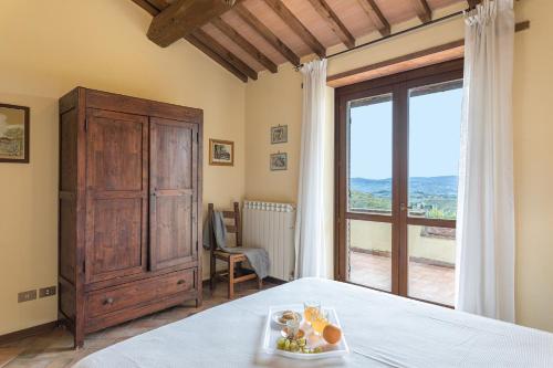 a bedroom with a bed and a large window at Villa Mila 6, Emma Villas in Gualdo Cattaneo