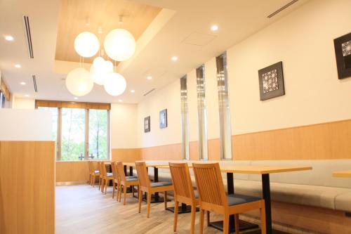 a dining room with a table and chairs at Rembrandt Style Tokyo Nishikasai Grande in Tokyo