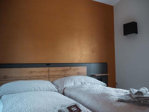 a bed with two white pillows in a bedroom at Stalder Meat & Bed in Muralto