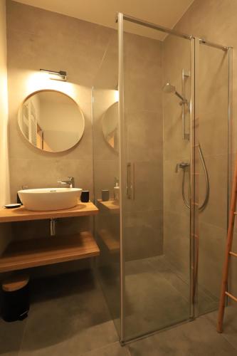 a bathroom with a glass shower and a sink at Apartmán Victory Port in Liptovský Mikuláš