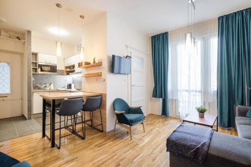 a living room with a couch and a table and chairs at BpR Blue Paradise Apartment with A/C in Budapest