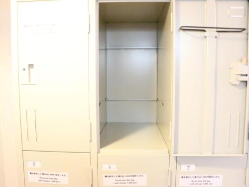 a walk in closet with white cabinets at Harimayabashi Guesthouse in Kochi