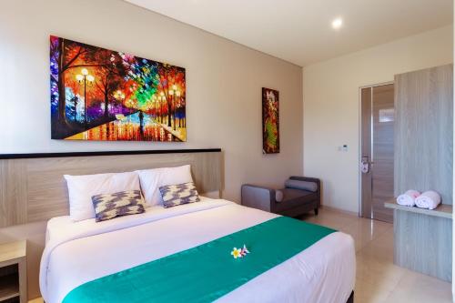 a bedroom with a bed and a painting on the wall at Nivasa Nusa Dua in Ungasan