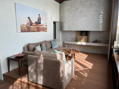 a living room with a couch and a fireplace at Les Jardins De La Koutoubia in Marrakech