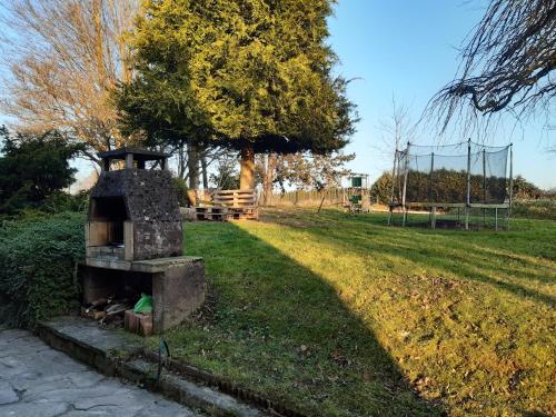 a brick oven in a field with a park at Gîte de la Grande Rainette in Grosne