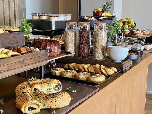 a bakery with bread and pastries on a counter at Castello Infinity Suites - Adults Only in Agia Pelagia