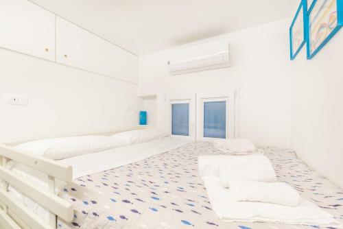 a white room with two beds and a staircase at La Perla del Mare, Terre Marine in Monterosso al Mare