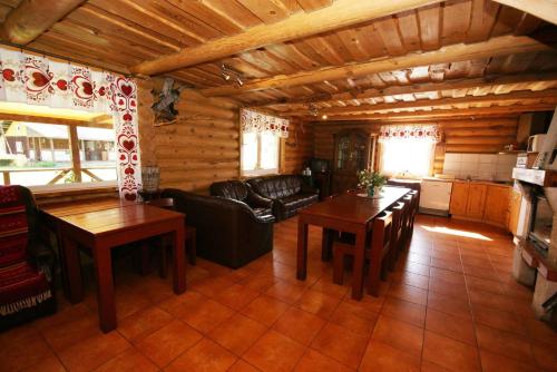 a living room with a couch and tables in a cabin at Likimo ratas in Paliepis