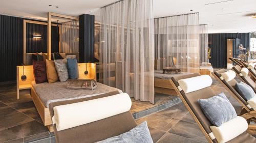 a hotel room with two beds and chairs at Hotel Restaurant Waldsägmühle in Pfalzgrafenweiler