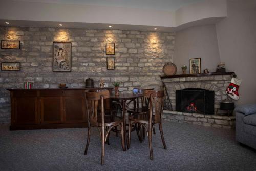 a dining room with a table and a fireplace at Δωμάτια με θέα in Méga Khoríon