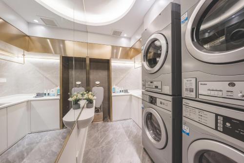 a laundry room with a washer and dryer at Atour Light Hotel Nanjing Fuzi Temple Zhonghuamen Station in Nanjing