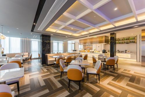 a restaurant with tables and chairs and a bar at Atour Hotel Nanjing Xianlin Center Jinying Plaza in Nanjing