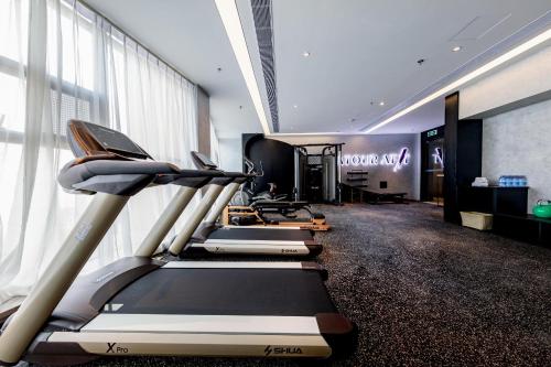a gym with treadmills and ellipticals in a room at Atour Hotel Wuhan Chuhehanjie Wuhan University in Wuhan