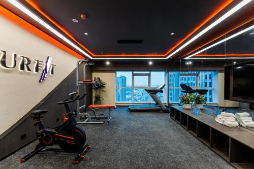 a gym with treadmills and exercise equipment in a building at Atour Hotel Xuzhou CBD in Xuzhou