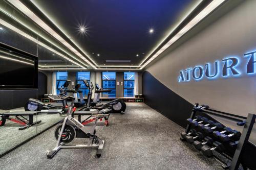 een fitnessruimte met loopbanden en machines in een kamer bij Atour Hotel Tongxiang South Qingfeng Road in Tongxiang