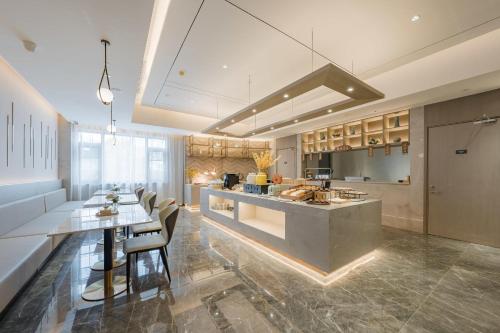 a large kitchen with a large island in a room at Atour Hotel Hangzhou East Railway Station in Hangzhou