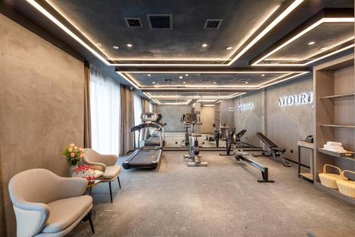 a gym with treadmills and treadles in a room at Atour Hotel Wuhan Guanggu Qingnianhui JinRongGang in Wuhan