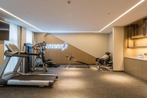 a gym with cardio equipment in a hotel room at Atour Hotel Nanjing Dongshan Cars 4S Park in Nanjing