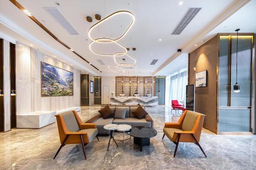 a living room with a couch and chairs at Atour Hotel Wuhan International Plaza Tongji Medical College of HUST in Wuhan