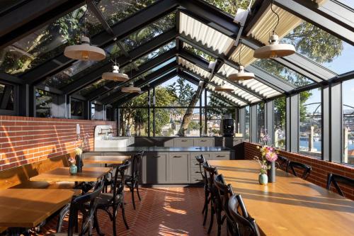a restaurant with tables and chairs and windows at CASA CAMÉLIA in Porto