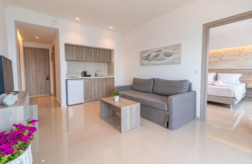 a living room with a couch and a kitchen at Orpheus Studios in Kos Town