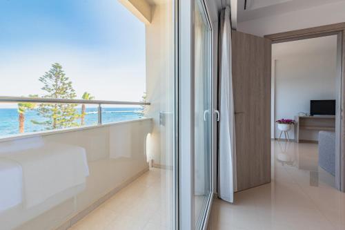a room with a balcony with a view of the ocean at Orpheus Studios in Kos Town