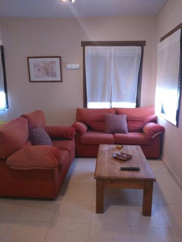 a living room with two couches and a coffee table at CASA RURAL RECIRUELOS in Peguerinos