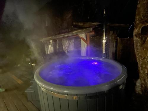 a hot tub filled with purple water in a barrel at Pirtiņa in Ogre