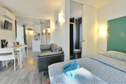 a hotel room with two beds and a bathroom at Polidor Camping Resort in Poreč