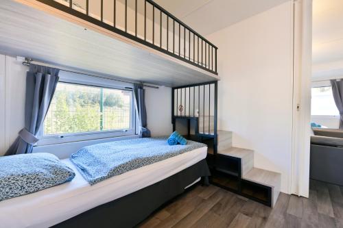 a bedroom with a bunk bed and a window at Polidor Camping Resort in Poreč