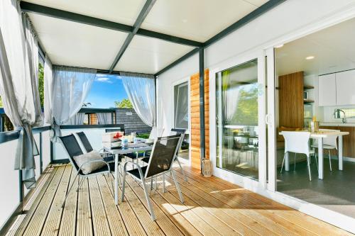 a room with a balcony with a table and chairs at Polidor Camping Resort in Poreč
