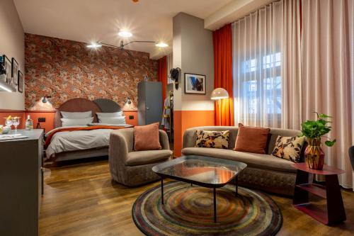 a living room filled with furniture and a fireplace at The Circus Hotel in Berlin