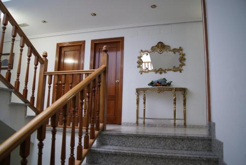 a stairway leading up to a room with a fire place at Hotel Praderón in San Sebastián de los Reyes
