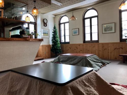 a large room with a table in the middle of it at Hotel El Mayo in Hakuba