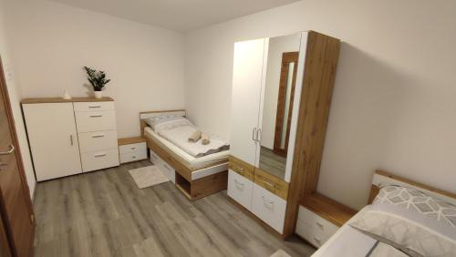 1 dormitorio con espejo, 1 cama y vestidor en Panorama Apartmenthaus, en Vöcklamarkt