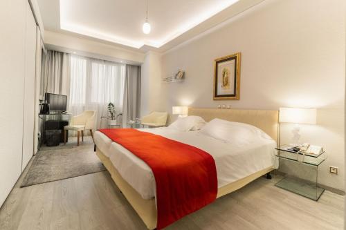 a hotel room with a bed and a desk at St George Lycabettus Lifestyle Hotel in Athens
