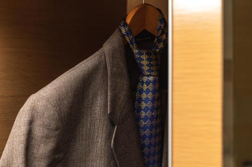 a suit and a tie hanging on a hanger at PrideInn Azure Hotel Nairobi Westlands in Nairobi