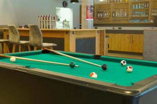 a pool table with balls on top of it at Zapfig Living Arlberg in Wald am Arlberg