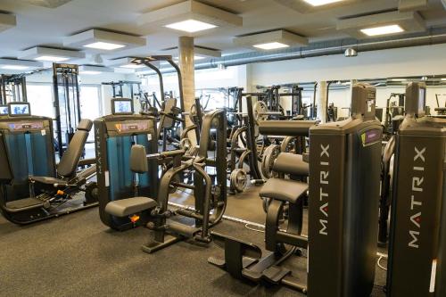 a gym with lots of treadmills and machines at Zapfig Living Arlberg in Wald am Arlberg