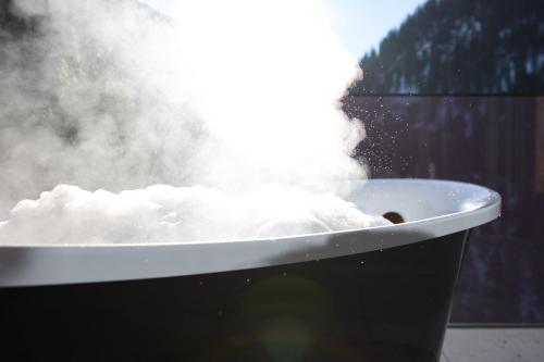 a bath tub filled with snow and steam at Luxury Apart Sailers including Premium Summercard in Sankt Anton am Arlberg