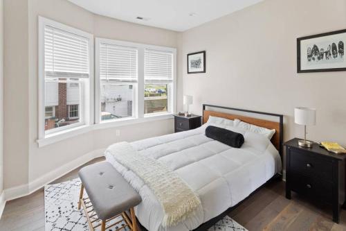 a white bedroom with a large bed and two windows at Renovated Beach Block 7BR North Beach Atlantic City - Steps to Beach & Casino in Atlantic City
