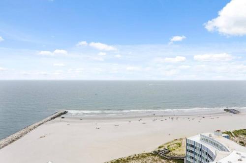 an aerial view of a beach with people on it at Renovated Beach Block 7BR North Beach Atlantic City - Steps to Beach & Casino in Atlantic City