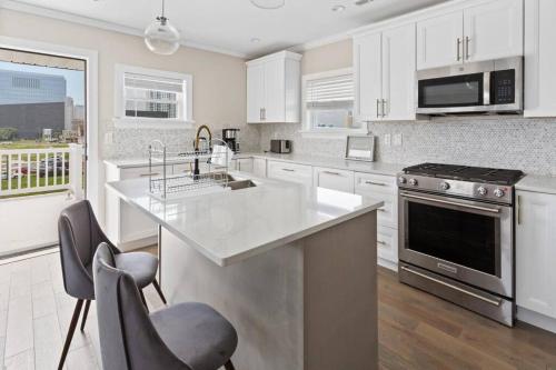 a white kitchen with a sink and a stove at Renovated Beach Block 7BR North Beach Atlantic City - Steps to Beach & Casino in Atlantic City